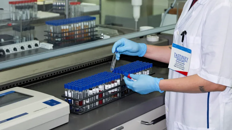 A biomedical scientist working with samples at a laboratory bench