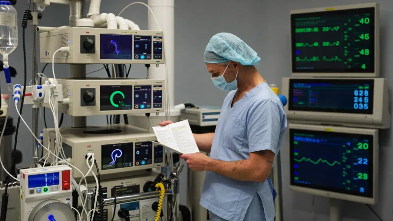 An operating department practitioner preparing anaesthetic equipment before a list